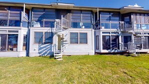 A modern two-story house with large windows and a covered front porch. - Jo's Hideaway, for Lake Erie lovers, fishermen and birders!  Sleeps 4 (Oak Harbor)