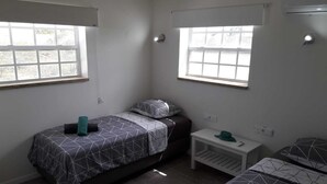 A small, clean room with two beds, a nightstand, and a window. - Villa Buena, fantastic luxury villa with internet/ wifi (Hato)