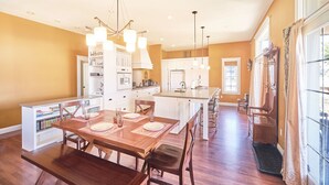 A spacious kitchen with a central island, white cabinetry, and pendant lighting. - Dogs friendly, In Town, Walk to Everything (BeachyK) (Long Beach)