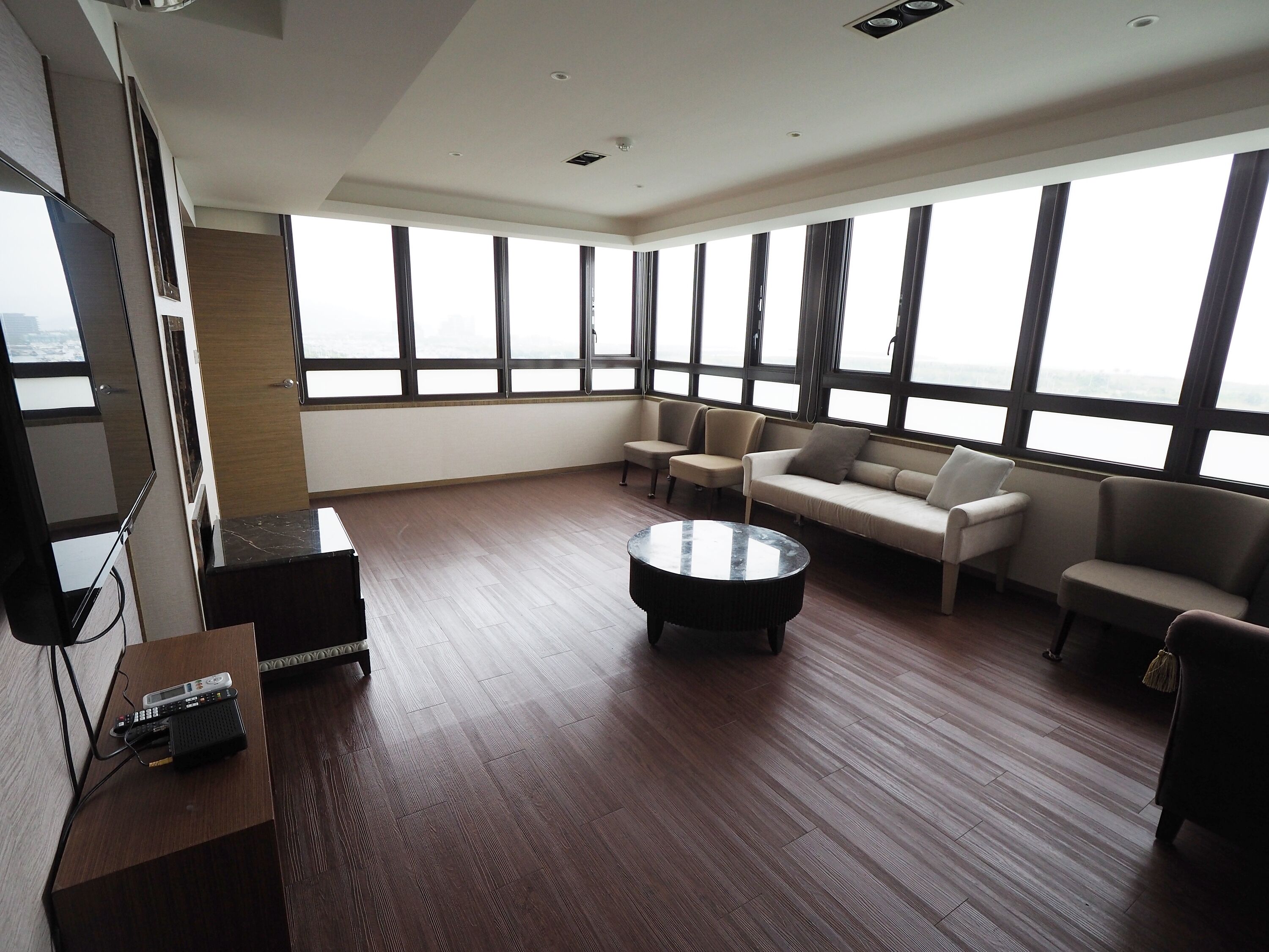 deluxe quadruple room | living area | flat-screen tv