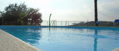 Seasonal outdoor pool, pool umbrellas, sun loungers