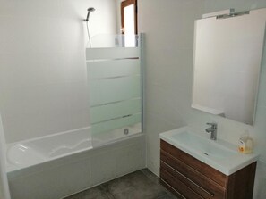 Bathtub, hair dryer, toilet paper