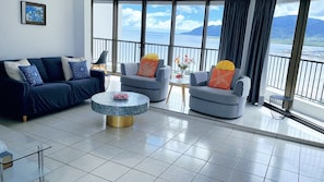 Enjoy a panoramic view of the water and distant mountains from this stylish living room.