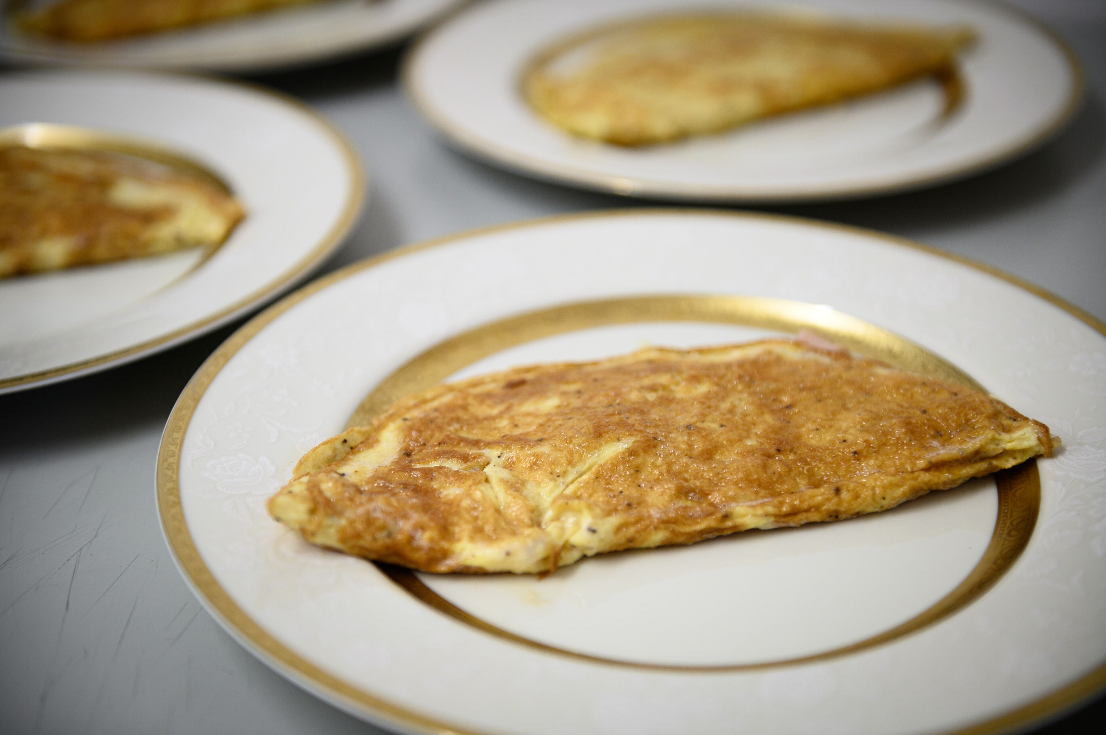 A close-up of a folded omelette on a plate.