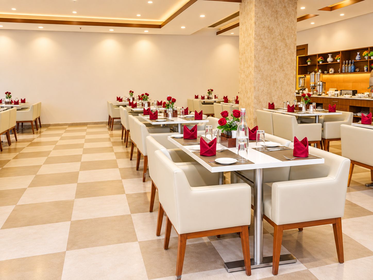 A restaurant with checkered flooring, white tables with red napkins, and a bar area with shelves.