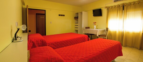 A room with two beds, a desk with a chair, a TV on the wall, and a door labeled 208. - Hotel Bari (Mendoza)