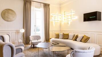 A modern living room with a sofa, armchairs, and a coffee table.