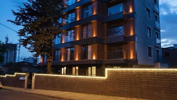 A multi-story hotel with a modern design, featuring balconies on each floor and a brick facade. - Princess Residence (Istanbul)