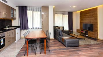 A modern apartment with a kitchen, dining area, and living room.
