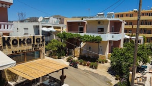 A building named Kokalas Resort Restaurant Bar with a visible outdoor seating area and a parked motorcycle. - Kokalas Resort (Apokoronas)