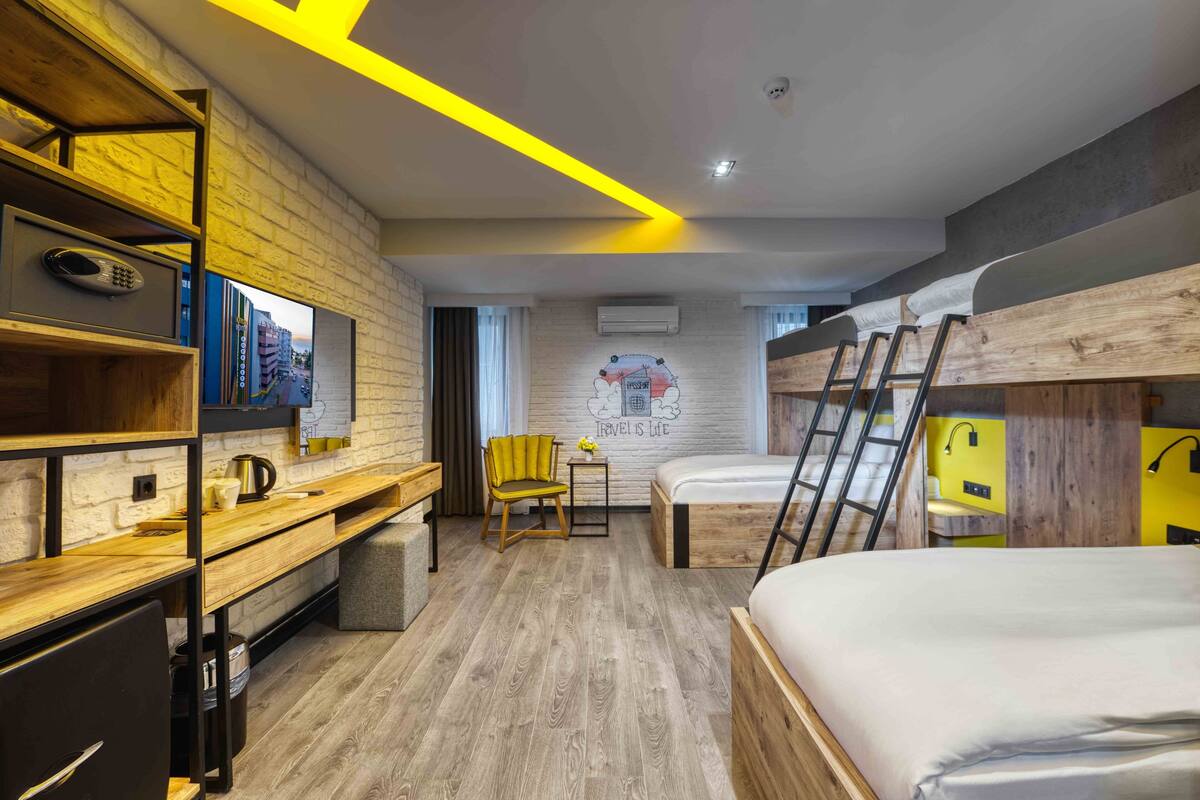 Deluxe Quadruple Room, City View | Minibar, in-room safe, desk, laptop workspace