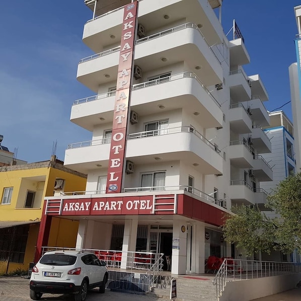 A multi-story building with a prominent sign reading "AKSAY APART HOTEL".