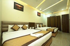 A hotel room with two beds, a ceiling fan, an air conditioning unit, and a view of the outside through curtains.