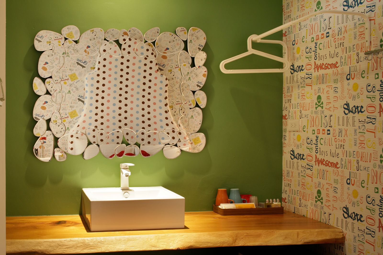 A bathroom with a sink, a mirror, and a towel rack.
