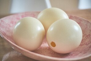 Three eggs on a pink plate.