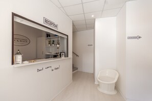 A reception area with a sign reading "RECEPTION" and a sign above the window that says "DANCE FINALE E & BEACH". - Residence Bike and Beach (Finale Ligure)