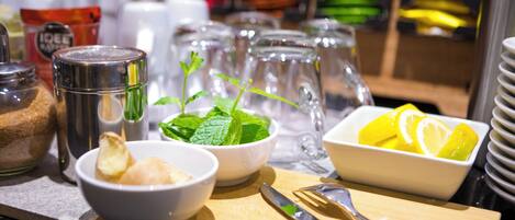 A breakfast buffet setup with various food items and condiments.