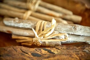 A bundle of wooden sticks tied together with a natural fiber.