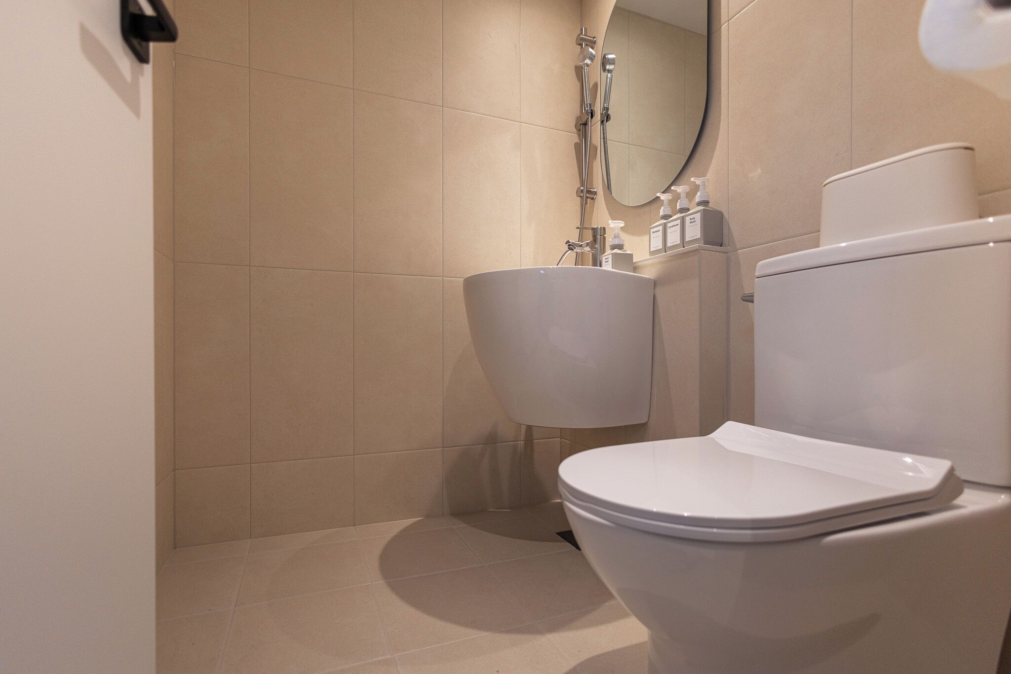 A bathroom with a toilet, sink, and shower.