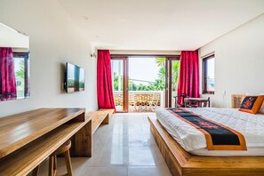 A modern hotel room with a wooden desk, a bed with a decorative bedspread, and a balcony with red curtains. - Opal Boutique Villa (Da Nang)