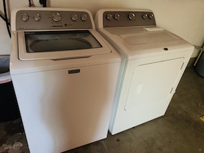 A Maytag washer and dryer unit with control knobs and a front panel. - The Gathering Place 3BR + Game Room (Keizer)