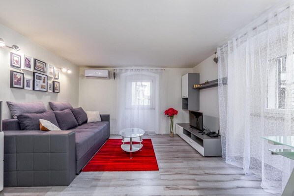 Apartamento, 1 quarto | Sala de estar | TV de tela plana