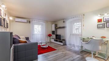 Apartment, 1 Bedroom | Living room | Flat-screen TV