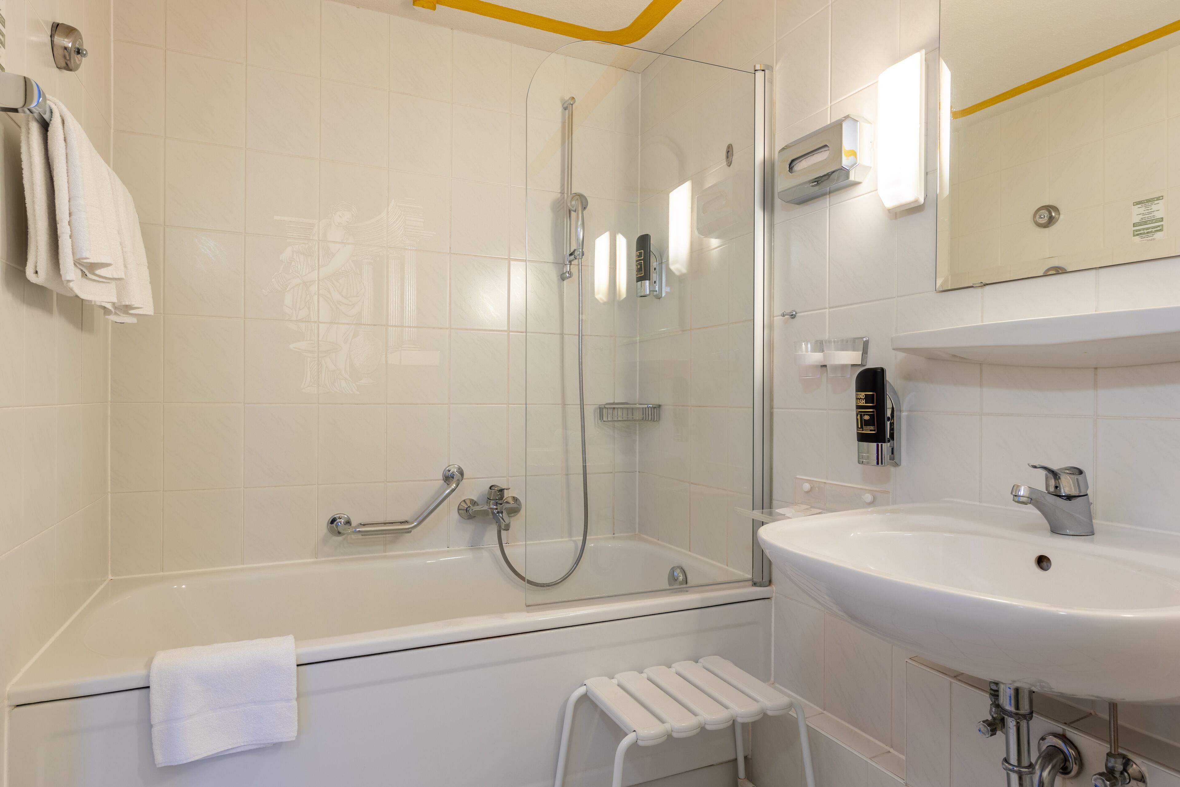 Ein modernes Badezimmer mit Badewanne, Dusche und Waschbecken.