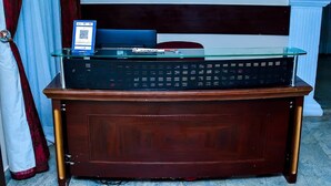 A wooden desk with a glass top, a computer, and a QR code. - The Emperor Place Annex (Lagos)