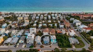 An aerial view of a coastal residential area with houses, a road, and a body of water. - Casa Azul - Adorable Home Close to the Beach with Private Pool & Patio! (Miramar Beach)