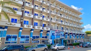 A multi-story hotel with balconies, a prominent sign, and several cars parked in front. - Dolphin Ras Elbar (Damietta)
