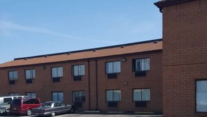 A multi-story brick building with a parking lot.
