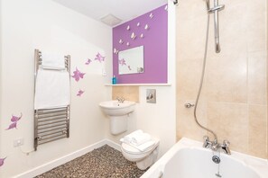 A bathroom with a toilet, sink, and bathtub. - Bouverie Apartment (Leeds)