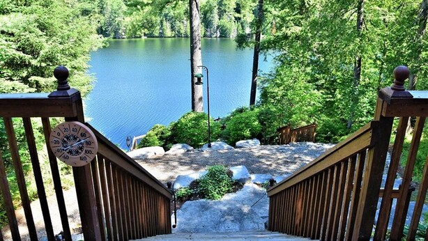 A wooden staircase leading to a lake surrounded by trees. - Stunning Cottage on a Very Private Lake (Kinmount)