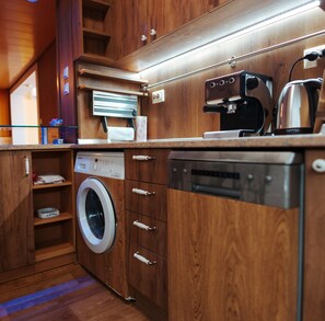 Enjoy a convenient kitchen with a dishwasher, washing machine, coffee maker, and kettle.