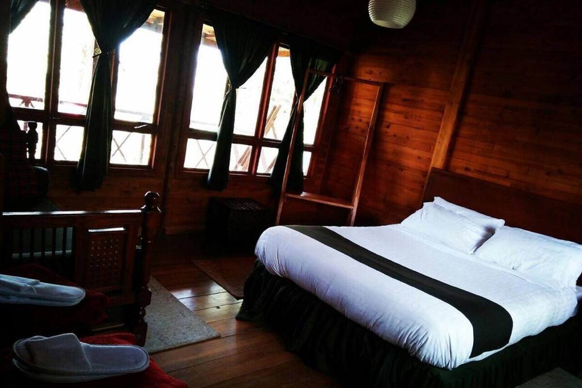 Um quarto aconchegante com uma cama, uma escrivaninha e uma cadeira.