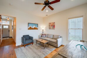 A spacious living room with a ceiling fan, a sofa, a coffee table, and a dining table. - Buena Vista Home w/ Mtn Views, Walk to Main St (Buena Vista)
