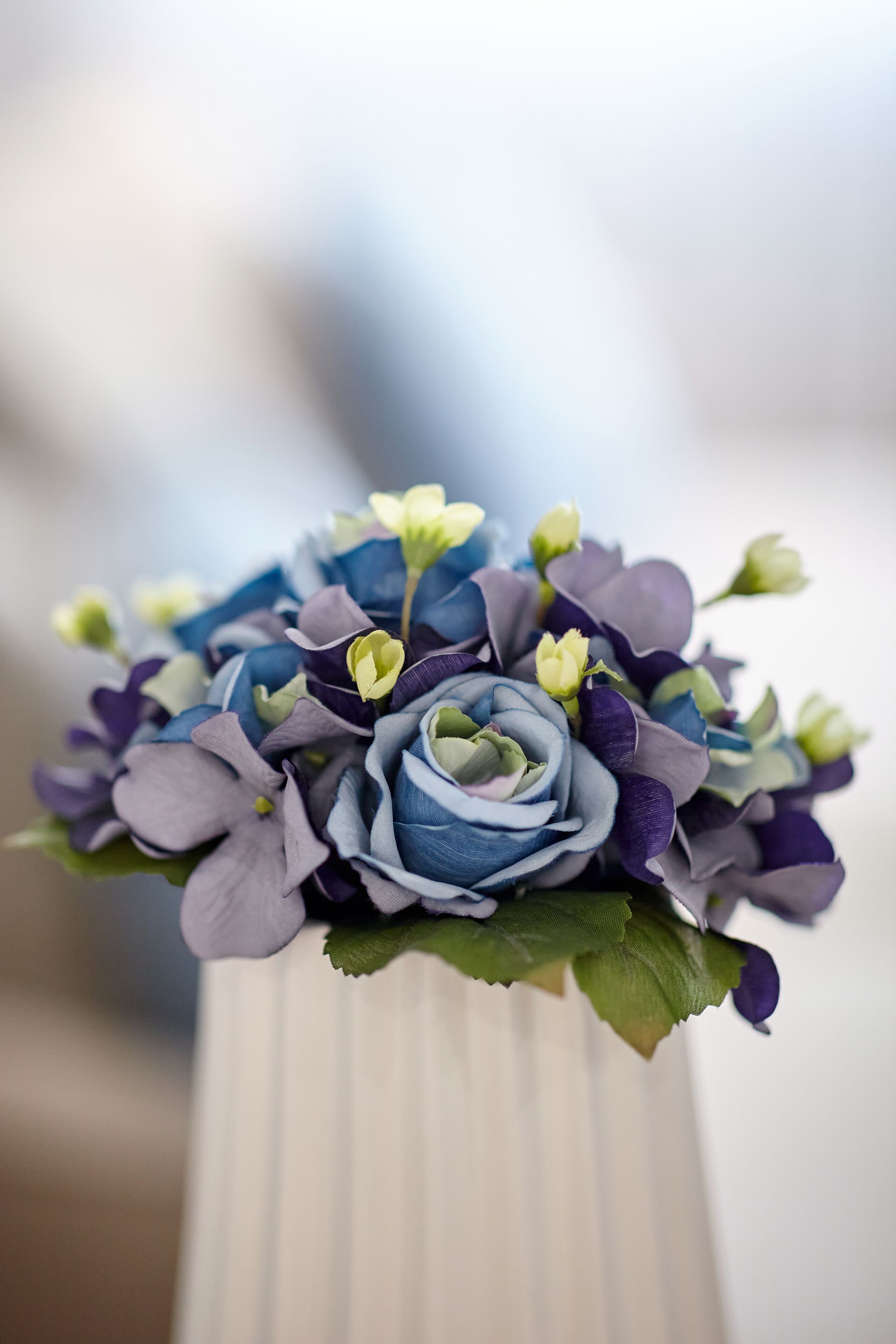 A bouquet of flowers in a white vase.