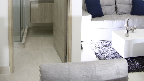 A modern bathroom with a large mirror, a sink, and a toilet. - Loft Mikonos - Adults Only (Pereira)