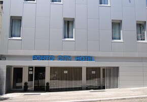 A modern building with a sign reading "PORTO CITY HOTEL".