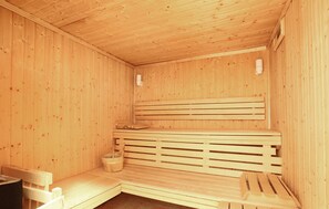 Relax in a cozy sauna with a slatted bench and a bucket for your comfort.