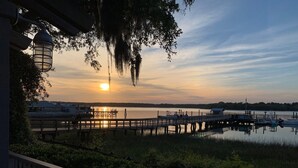 A sunset view from a dock with boats and a pier. - Luxury Home in Old Town Bluffton + FREE Golf Cart. Sleeps 8 - Downtown location (Bluffton)