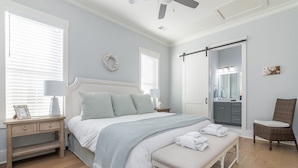 A bedroom with a bed, bedside table, bench, and a chair. - Luxury Home in Old Town Bluffton + FREE Golf Cart. Sleeps 8 - Downtown location (Bluffton)