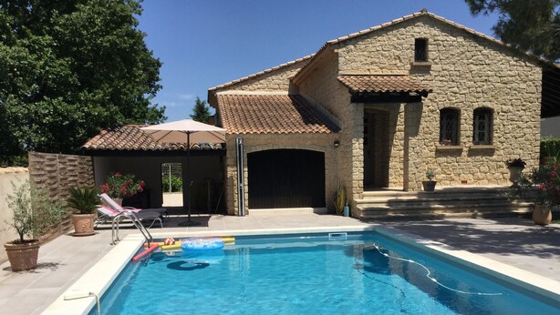 A swimming pool with a stone building in the background.