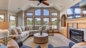 A spacious living room with a sectional sofa, a round coffee table, and a fireplace. - Duck Tales | 2400 ft from the beach | Private Pool, Hot Tub | Duck (Duck)