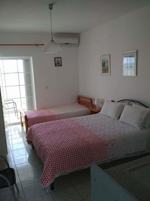 Habitación triple, vistas al mar | Tabla de planchar con plancha, cunas gratuitas, wifi gratis
