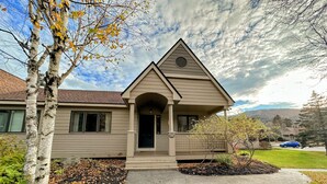 A single-story house with a gabled roof, a front porch, and a number '36' on the front door.