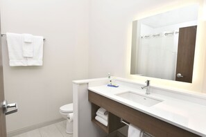 A modern bathroom with a white sink, a mirror, and a toilet. - Holiday Inn Express & Suites Madisonville by IHG (Madisonville)