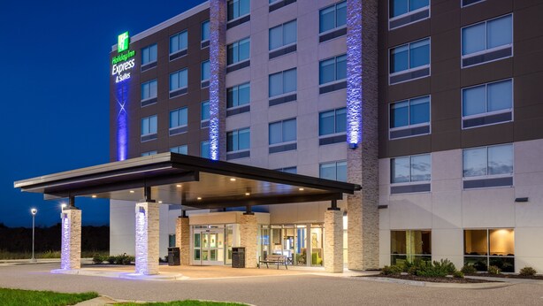 A Holiday Inn Express building with a covered entrance, multiple floors, and a well-lit facade. - Holiday Inn Express & Suites Beloit by IHG (Beloit)