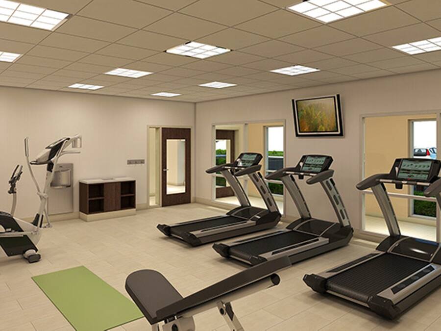 A fitness center with treadmills, a stationary bike, and a rowing machine.